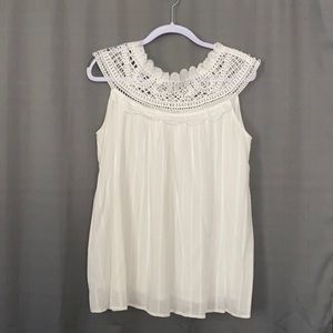 Sleeveless top with crocheted neck.